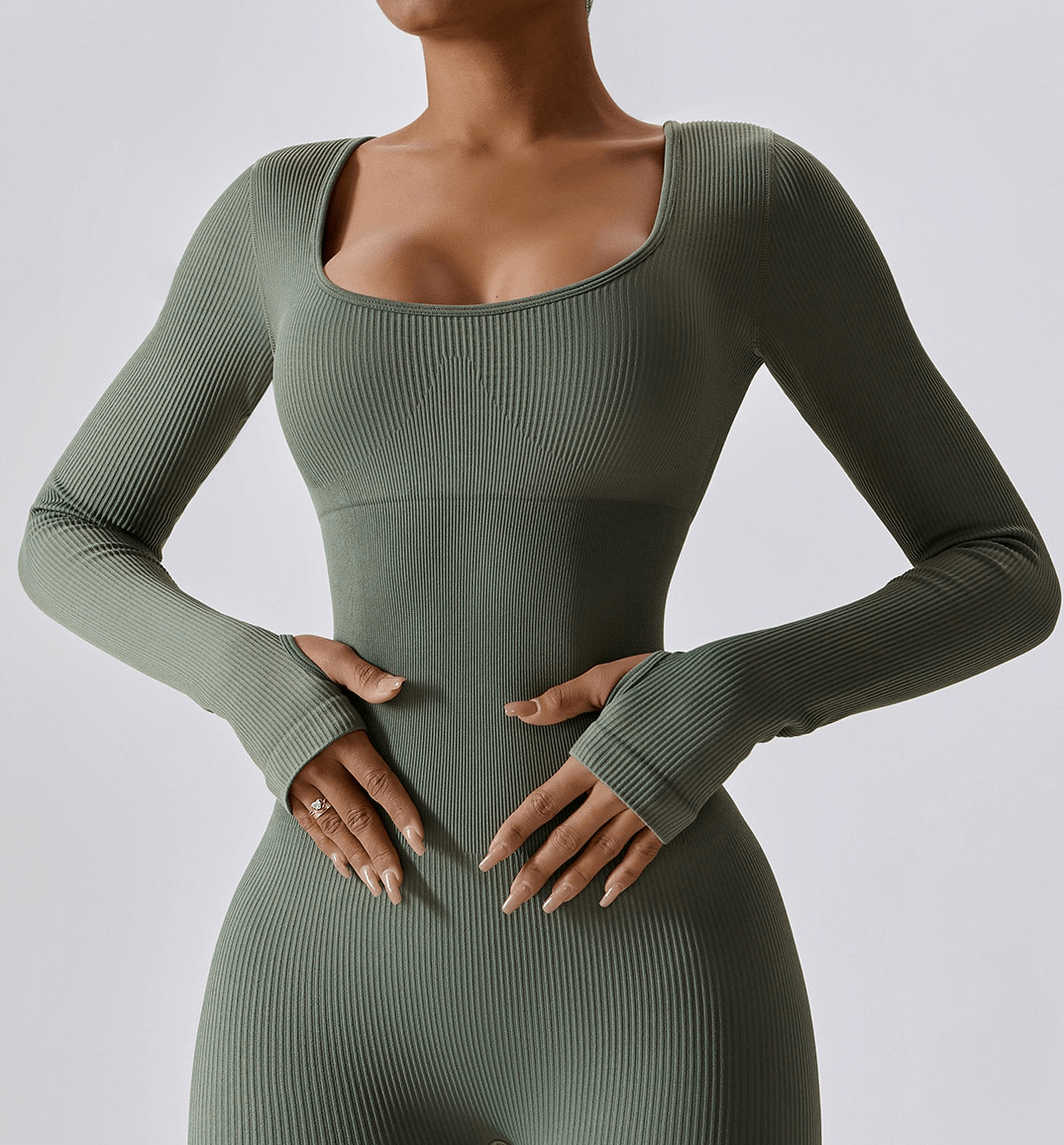 Stylish green seamless yoga suit with thumb holes for women, offering comfort and flexibility for workouts or athleisure.